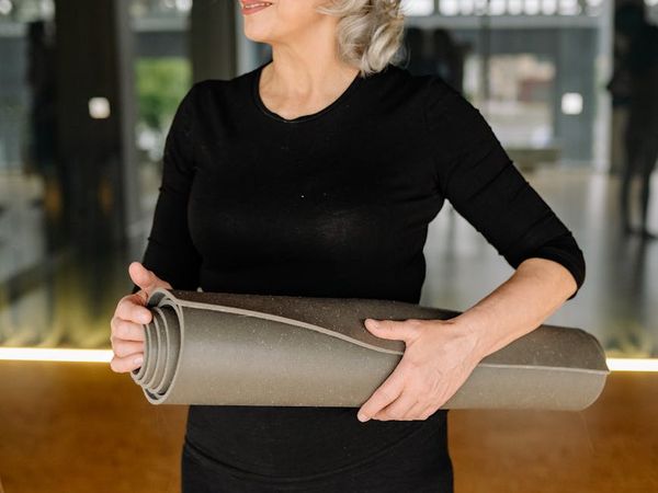 A woman holding a challenging yoga pose demonstrating physical strength.