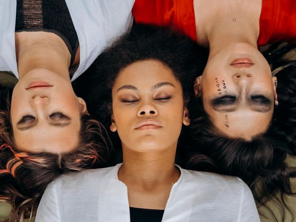 Group of diverse people performing a balancing yoga pose together.